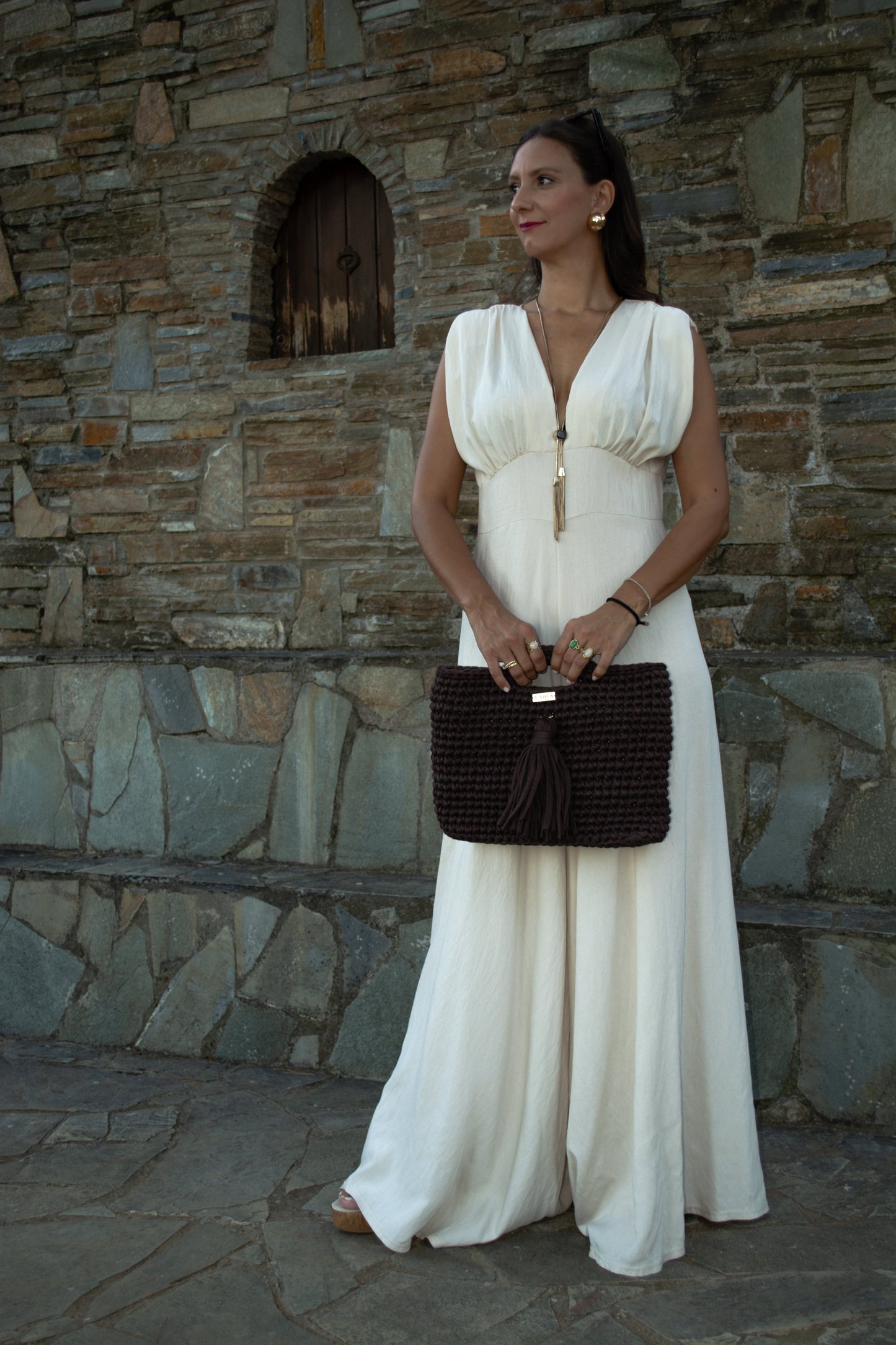 Elegant women's jumpsuit with shoulder pads and deep neckline in lightweight tequila fabric