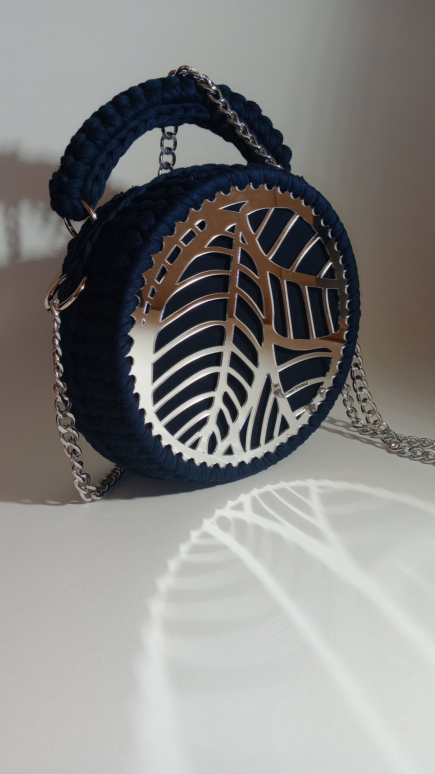 Elegant handmade shoulder crochet bag in soft pop tones, featuring a round embossed design and a metallic accent. Crafted with eco-friendly yarn, lightweight and versatile—ideal for elevating both casual and dressy looks.