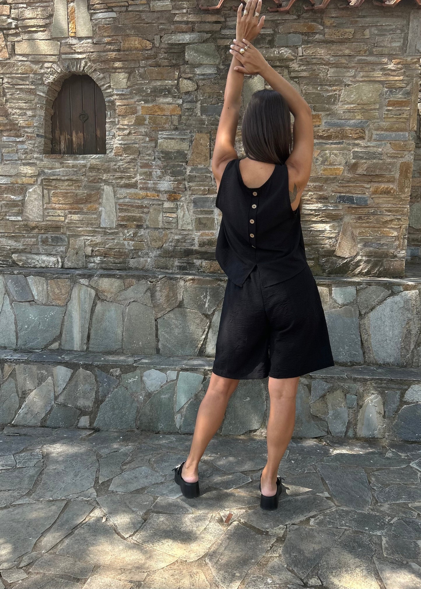 Women's sleeveless tank top with back buttons — lightweight fabric and modern minimal design for everyday wear.