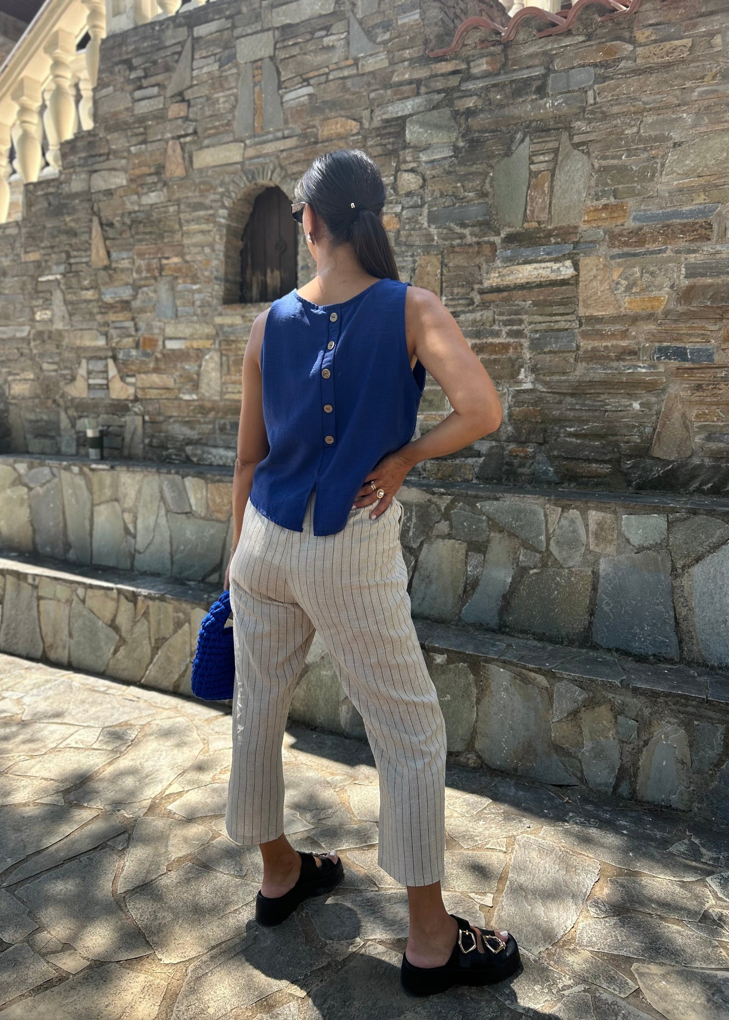 Women's sleeveless tank top with back buttons — lightweight fabric and modern minimal design for everyday wear.
