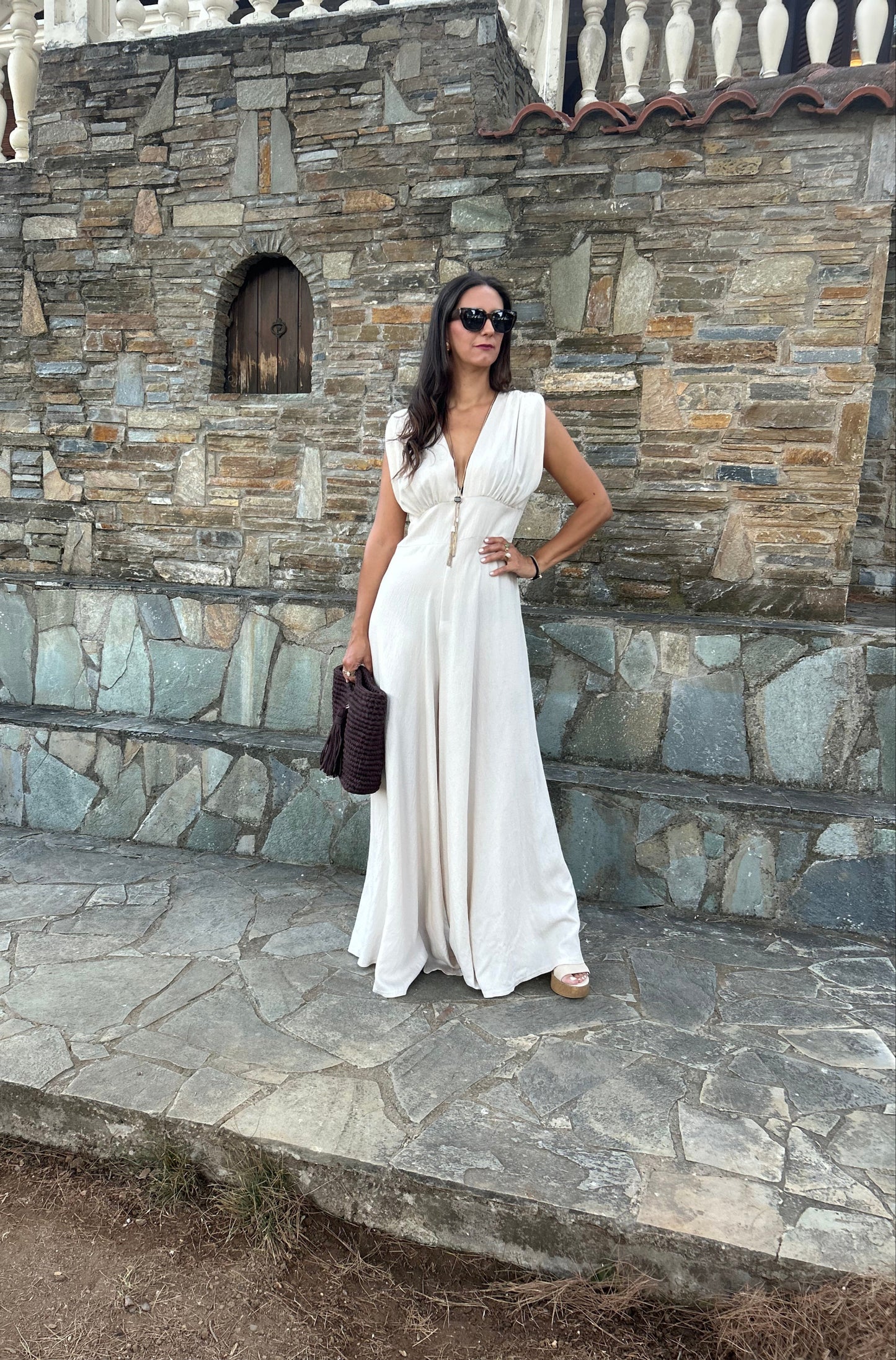 Elegant women's jumpsuit with shoulder pads and deep neckline in lightweight tequila fabric