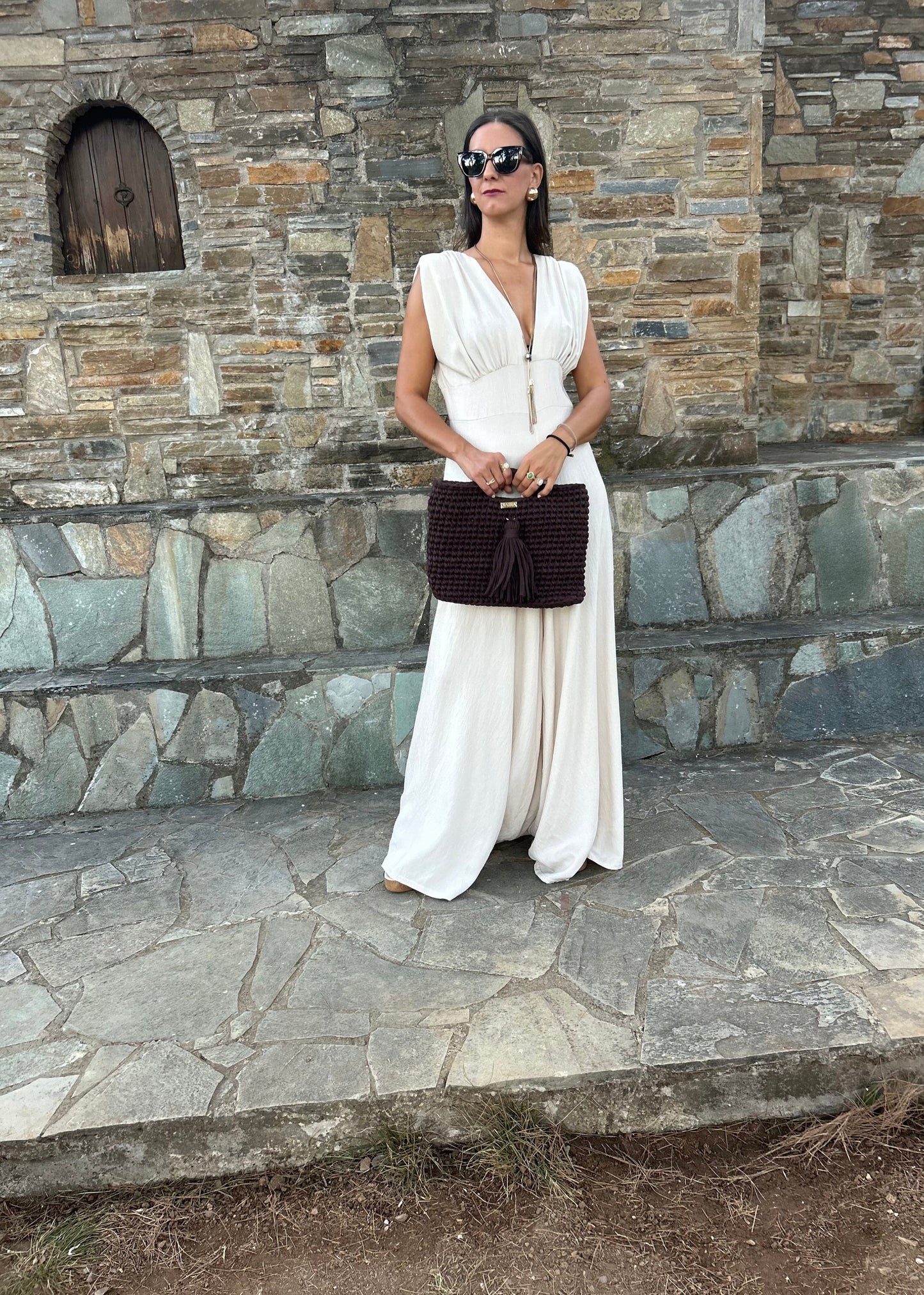 Elegant women's jumpsuit with shoulder pads and deep neckline in lightweight tequila fabric