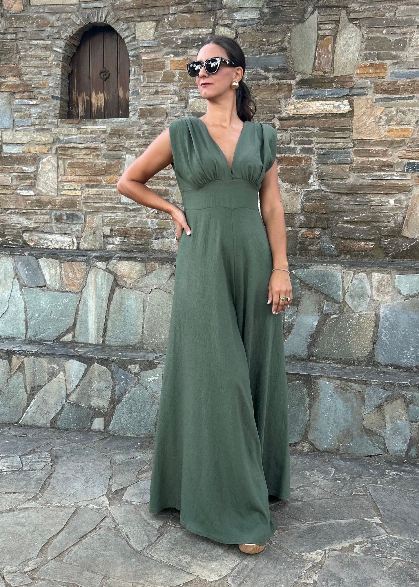 Elegant women's jumpsuit with shoulder pads and deep neckline in lightweight tequila fabric