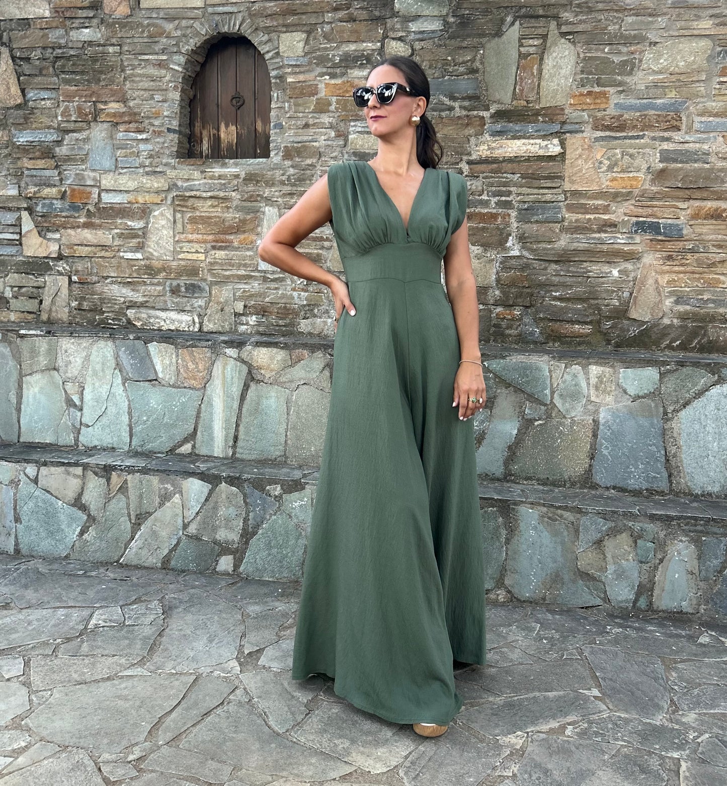 Elegant women's jumpsuit with shoulder pads and deep neckline in lightweight tequila fabric