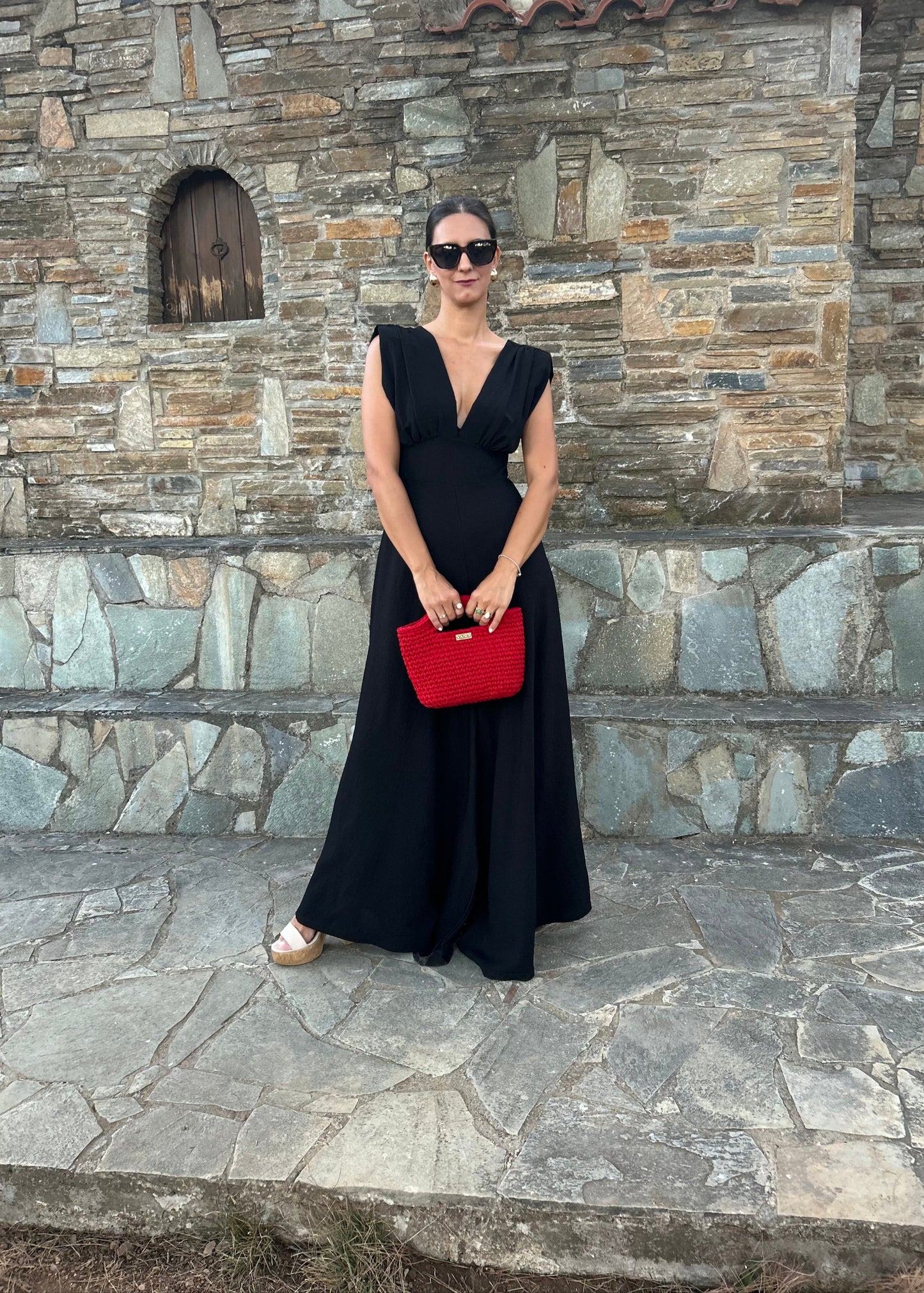 Elegant women's jumpsuit with shoulder pads and deep neckline in lightweight tequila fabric