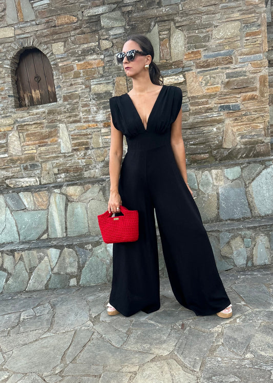 Elegant women's jumpsuit with shoulder pads and deep neckline in lightweight tequila fabric