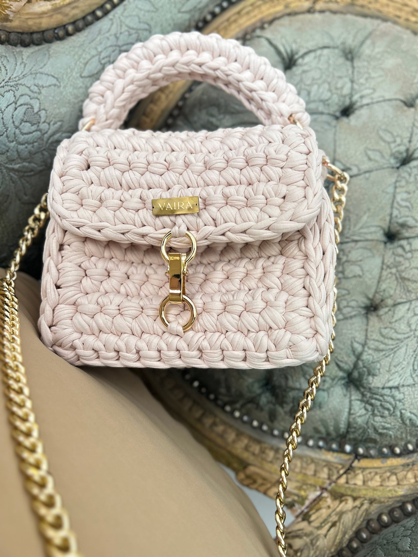 Entirely handcrafted with a unique stitch and golden chain, this petite yet charming shoulder bag brings everyday elegance to life. Perfectly sized for your essentials, it features a standout closure and luxurious texture — a true style statement born from the art of handmade creation.