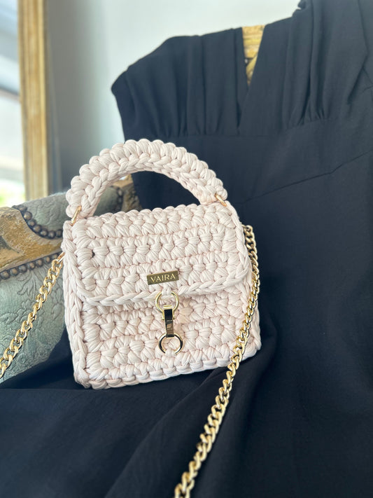 Entirely handcrafted with a unique stitch and golden chain, this petite yet charming shoulder bag brings everyday elegance to life. Perfectly sized for your essentials, it features a standout closure and luxurious texture — a true style statement born from the art of handmade creation.