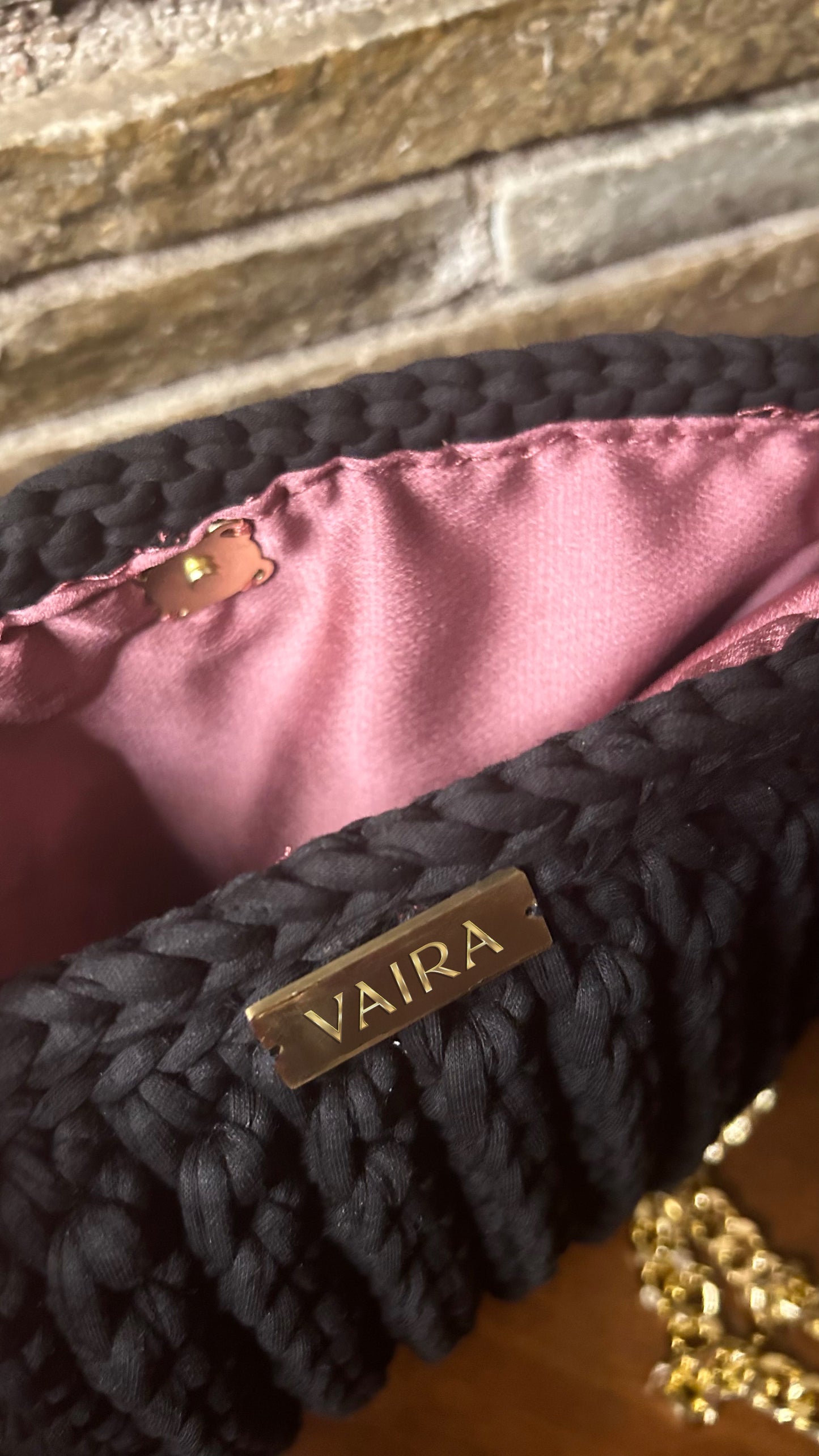 Handmade black crochet shoulder bag, featuring a gold chain strap, side keychain, zipper closure, and inner lining