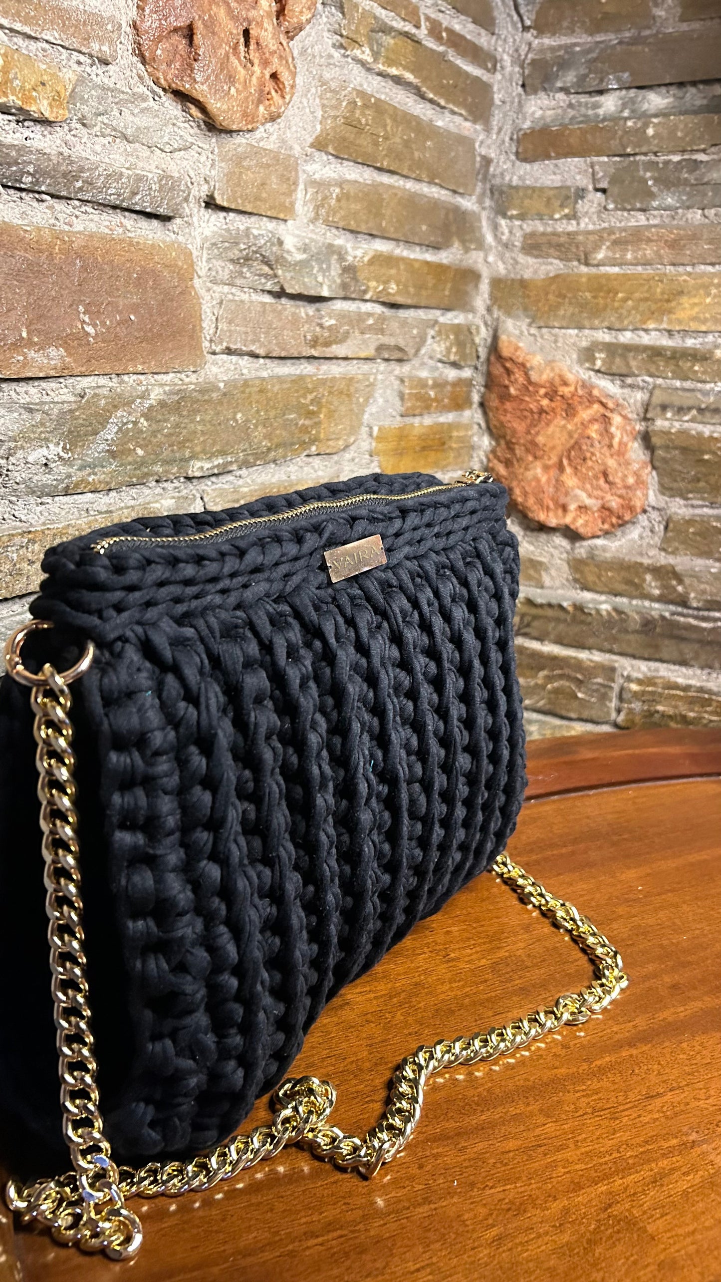 Handmade blue and black crochet shoulder bag, featuring a gold chain strap, side keychain, zipper closure, and inner lining