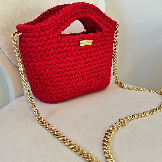 Handcrafted crochet shoulder bag in rich, passionate tones, featuring a textured weave, optional gold chain strap, and elegant design. Lightweight, medium-sized, water-repellent, and made in Greece with attention to detail.