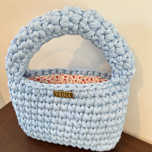Handwoven women's handbag in a romantic baby blue color, featuring textured crochet pattern. Compact yet spacious, styled with playful boho charm. Pairs effortlessly with denim and flowy dresses