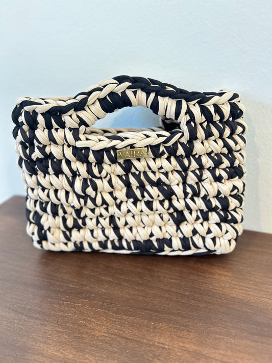 Handmade crochet women's bag in vibrant pop colors, crafted from eco-friendly yarn. Stylish and modern, perfect for casual denim looks.