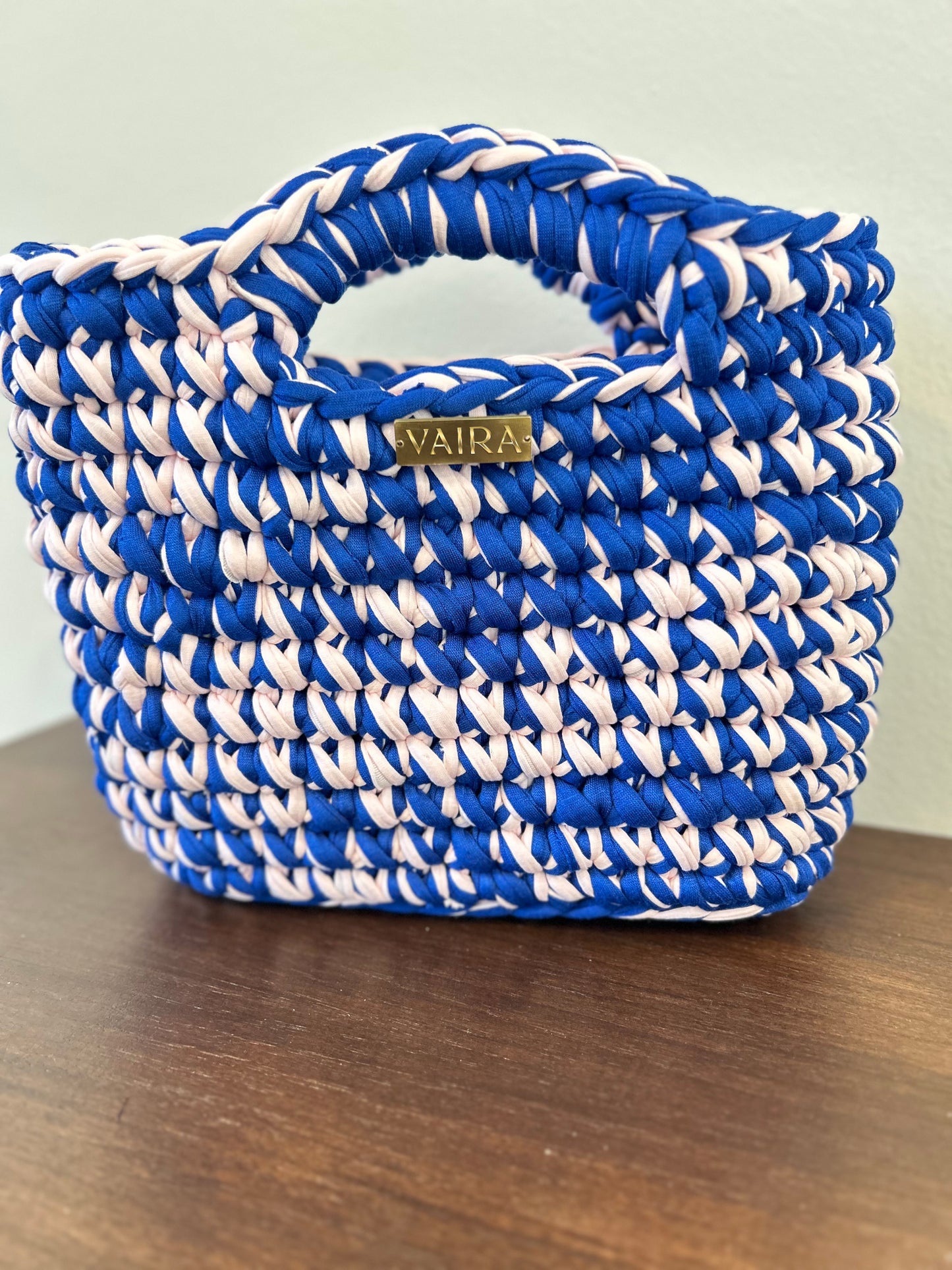 Handmade crochet women's bag in vibrant pop colors, crafted from eco-friendly yarn. Stylish and modern, perfect for casual denim looks.