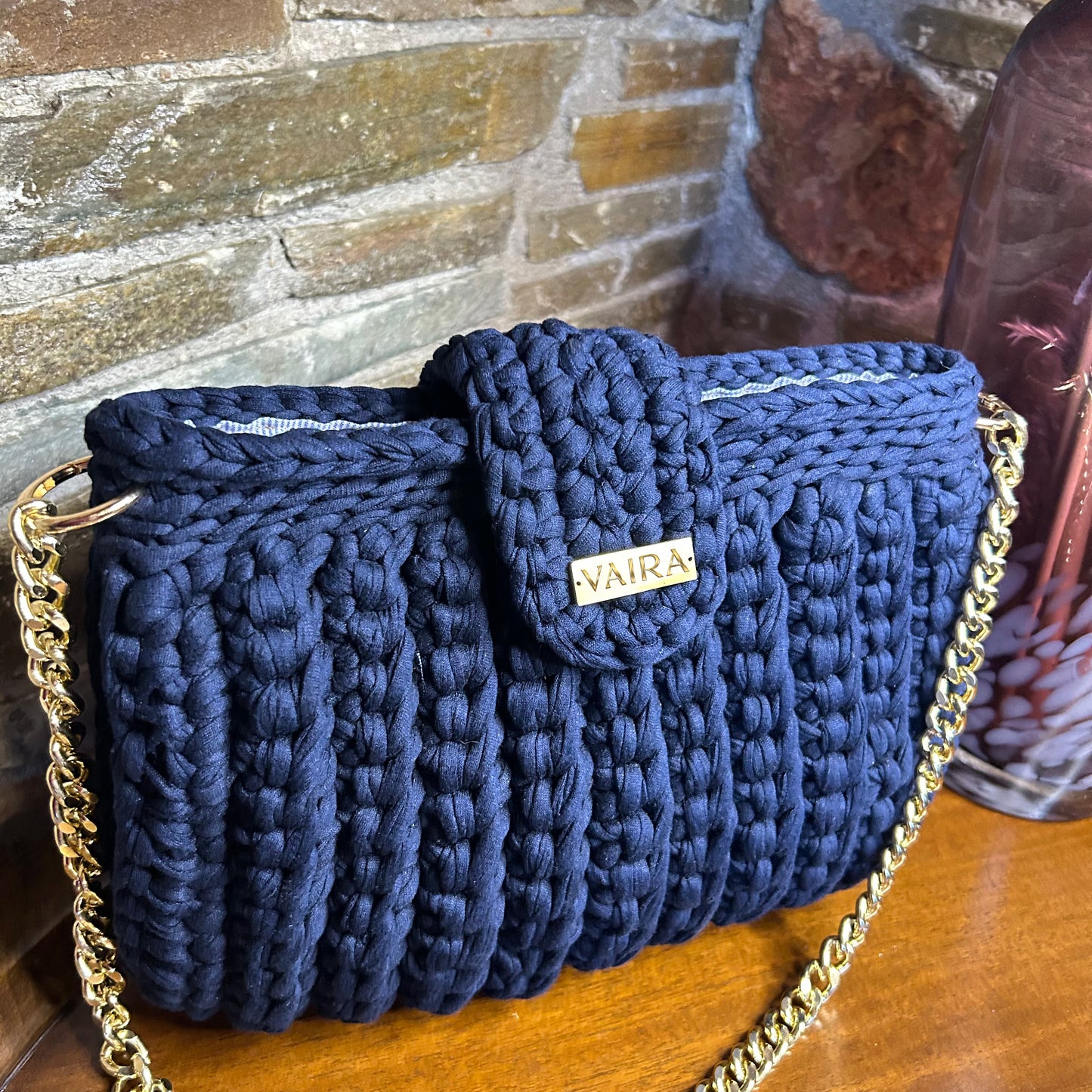 Handmade blue crochet shoulder bag, featuring a gold chain strap, side keychain, zipper closure, and inner lining