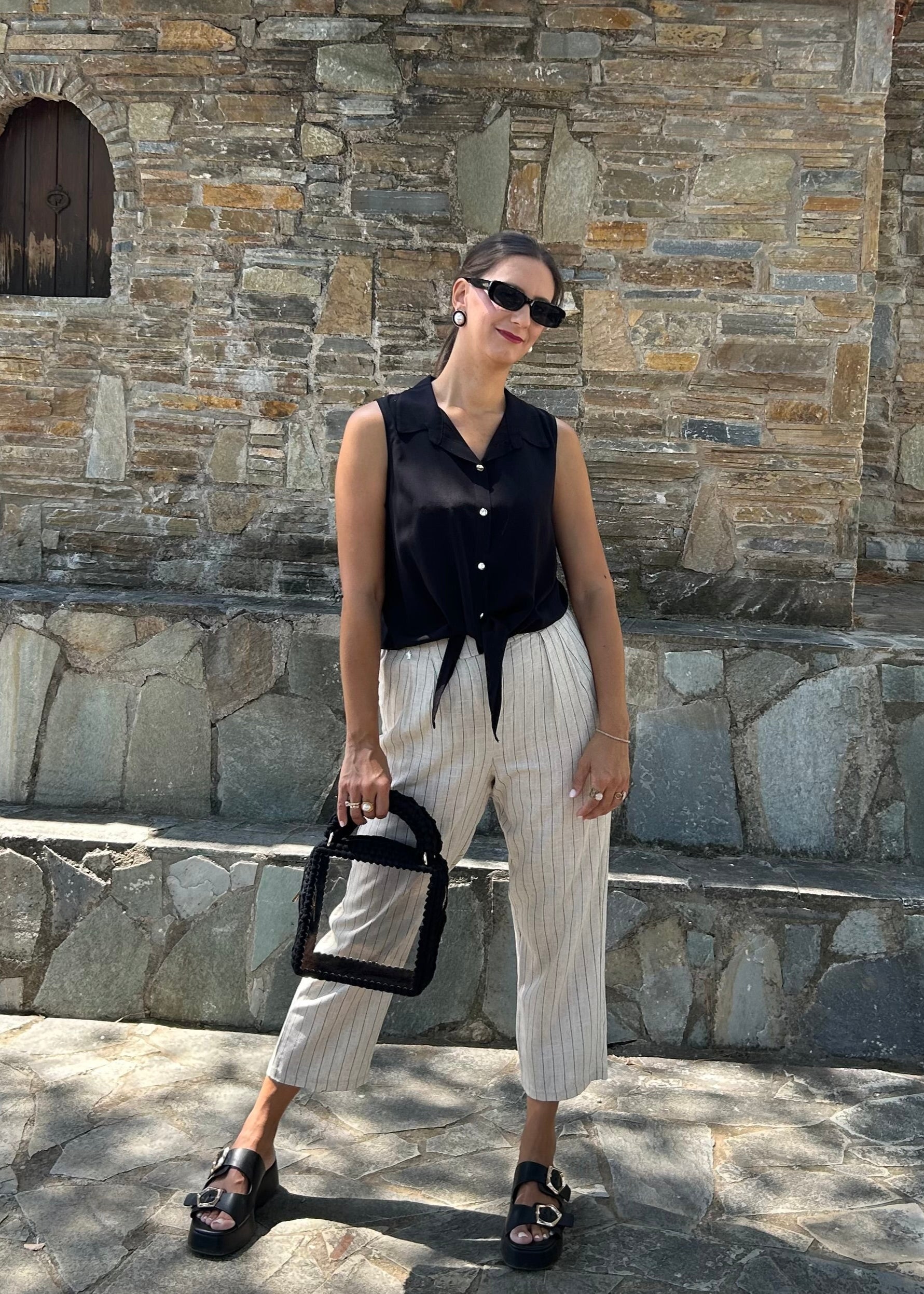 Women's sleeveless top in lightweight tequila fabric, available in black, white, and salmon — perfect for all-day wear and versatile styling.