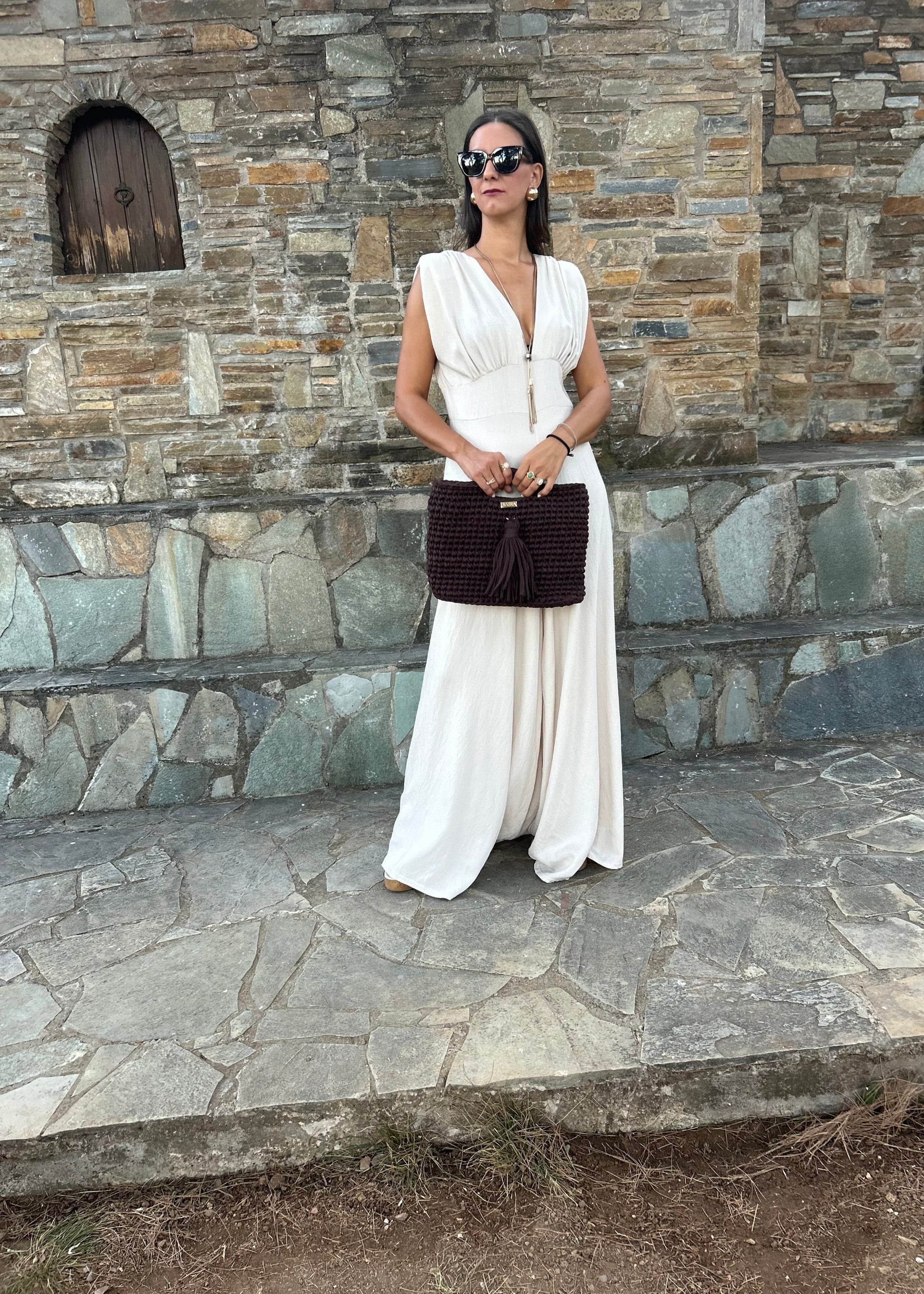 Elegant women's jumpsuit with shoulder pads and deep neckline in lightweight tequila fabric