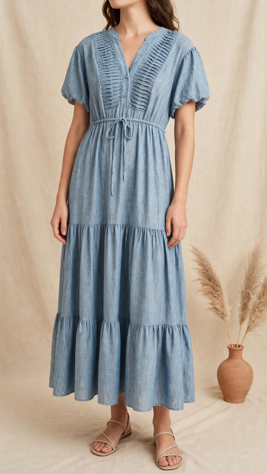 Ανακαλύψτε το γυναικείο maxi φόρεμα "Isidora" σε denim blue απόχρωση. Αέρινο με πλίσεις στο μπούστο, φουσκωτά μανίκια & ρυθμιζόμενο κορδόνι. Αποκτήστε το!
