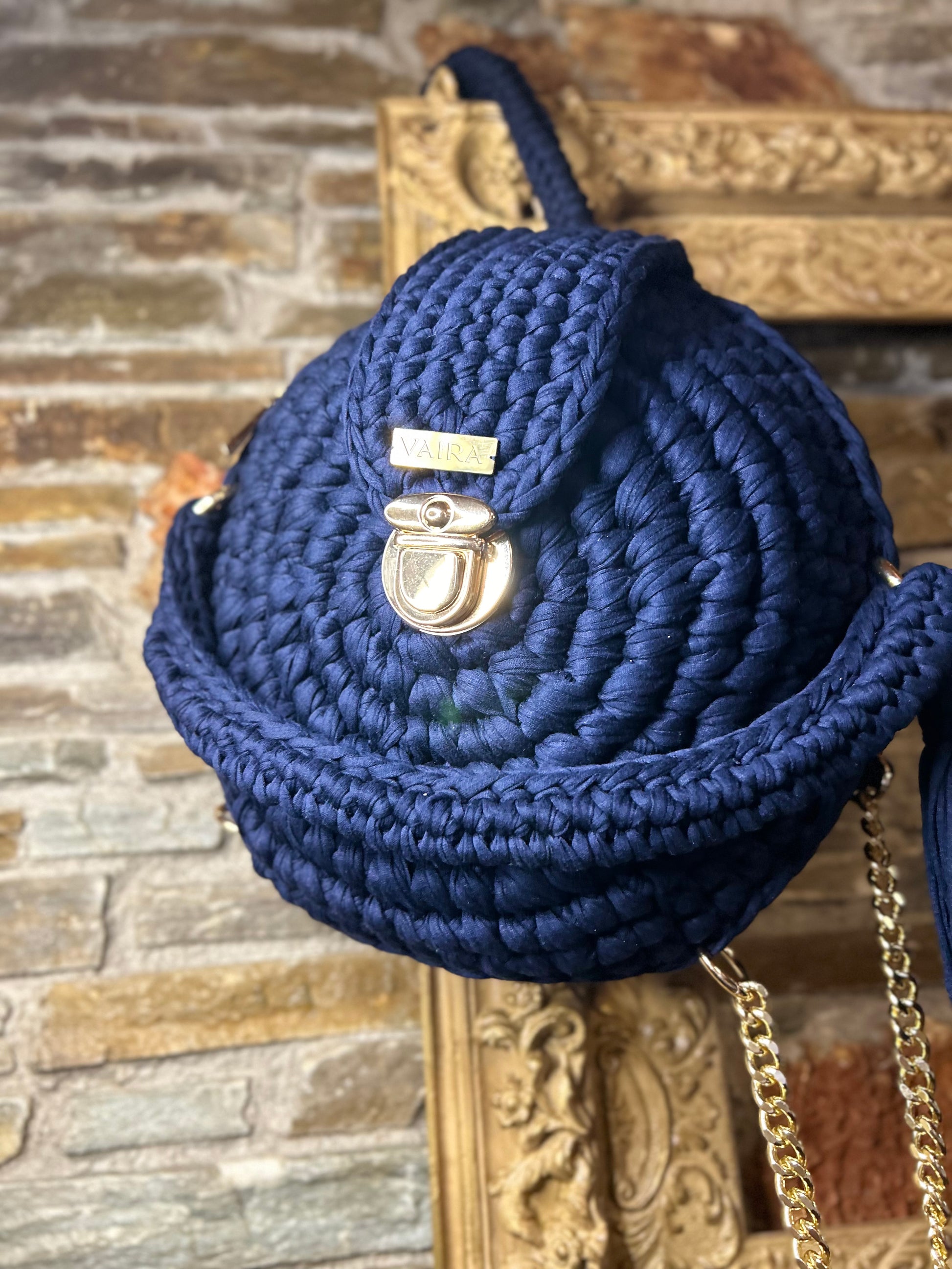 Handmade round blue crochet shoulder bag with matching wallet, featuring a metal and thread strap.