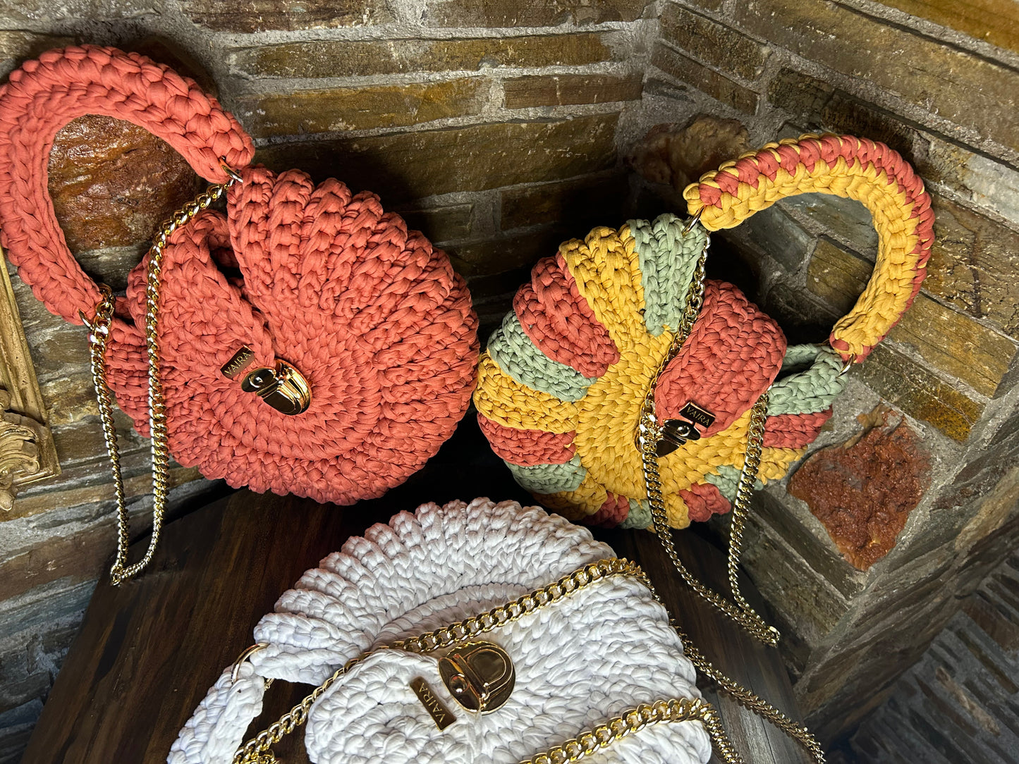 Handmade round multicolor crochet shoulder bag, featuring a metal and thread strap.