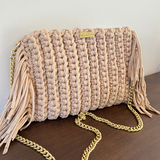 Handcrafted shoulder bag with gold chain and fine fringe details, featuring textured weave and elegant boho flair.
