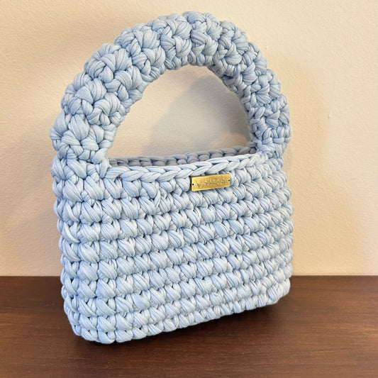Handwoven women's handbag in a romantic baby blue color, featuring textured crochet pattern. Compact yet spacious, styled with playful boho charm. Pairs effortlessly with denim and flowy dresses