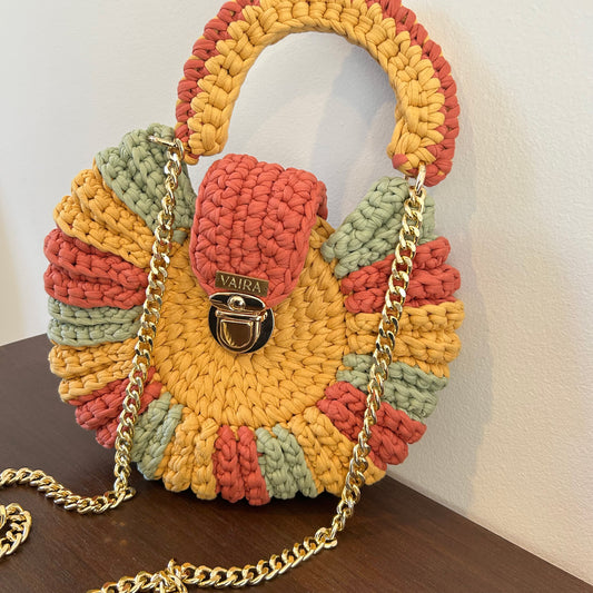 Handmade round multicolor crochet shoulder bag, featuring a metal and thread strap.