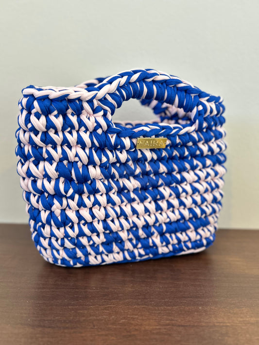 Handmade crochet women's bag in vibrant pop colors, crafted from eco-friendly yarn. Stylish and modern, perfect for casual denim looks.