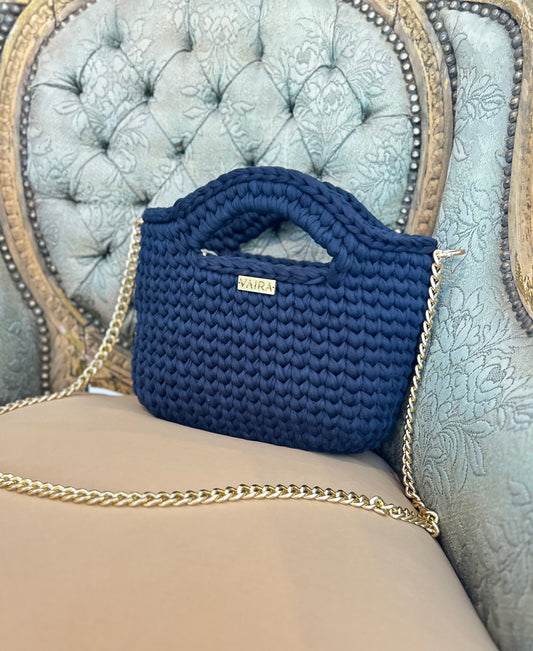Handcrafted crochet shoulder bag in rich tones, featuring a textured weave, optional gold chain strap, and elegant design. Lightweight, medium-sized, water-repellent, and made in Greece with attention to detail.