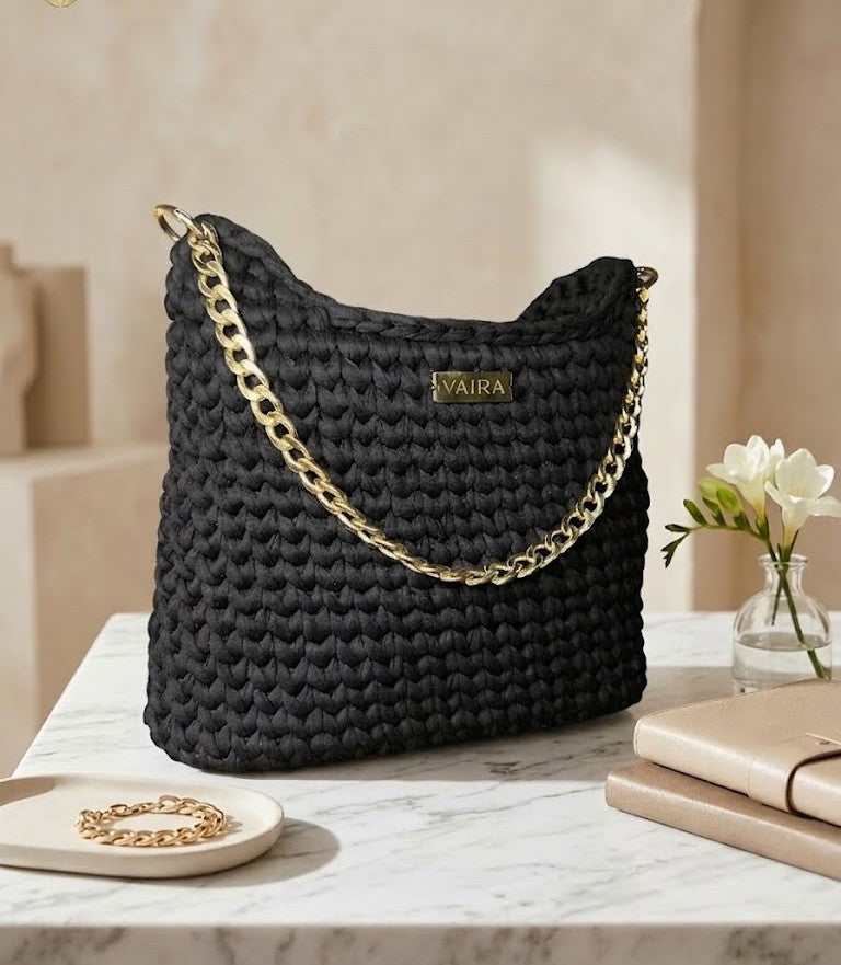 Handmade black crochet shoulder bag, lined interior, youthful and modern design